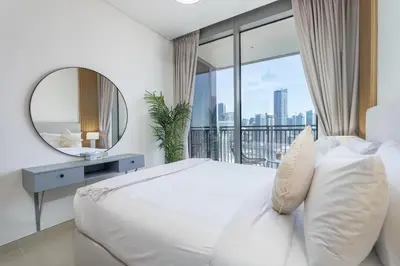 a bedroom with a large bed and a mirror at Vogue Marina 52-42 Towers near Ain Dubai and JBR Beach, Two Bedroom Apartment with Balcony Canal and Skyline views, Access to all Amenities in Dubai