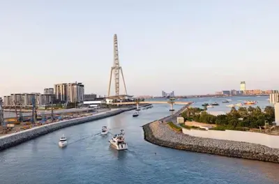 a group of boats in a river with buildings at Vogue Marina 52-42 Towers near Ain Dubai and JBR Beach, Two Bedroom Apartment with Balcony Canal and Skyline views, Access to all Amenities in Dubai