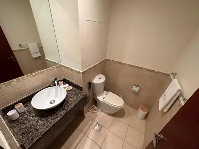 a bathroom with a sink and a toilet at Centrally Located Close to Beach in Dubai