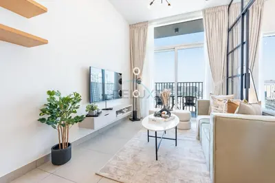 a living room with a couch and a table at Located Minutes walk to Dubai Hills Park, Near Dubai Hills Mall , Socio Tower 1, Dubai Hills by Deluxe Holiday Homes in Dubai