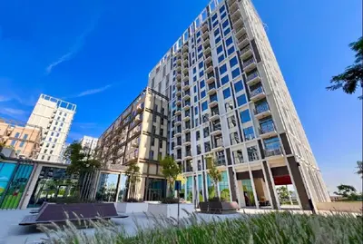 a large apartment building with windows on a clear day at Located Minutes walk to Dubai Hills Park, Near Dubai Hills Mall , Socio Tower 1, Dubai Hills by Deluxe Holiday Homes in Dubai