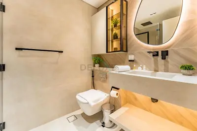 a bathroom with a toilet and a sink and a mirror at Golf Course And Canal Views, Mins to Dubai Marina And Dubai Mall, Golf Towers T1 - The Greens by Deluxe Holiday Homes in Dubai