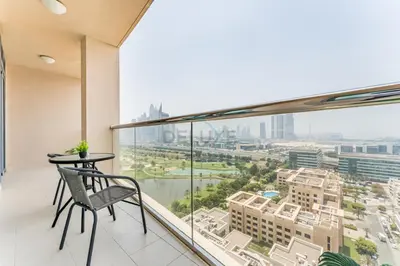 a balcony with a table and a view of a city at Golf Course And Canal Views, Mins to Dubai Marina And Dubai Mall, Golf Towers T1 - The Greens by Deluxe Holiday Homes in Dubai