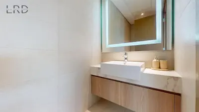 a bathroom with a sink and a mirror at Cozy and Modern 1BR for 2 in Dubai