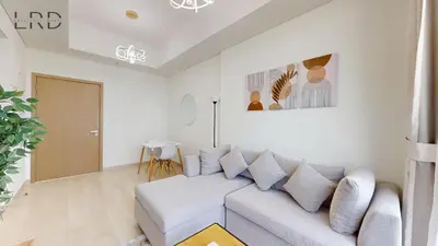 a white living room with a couch and a door at Cozy and Modern 1BR for 2 in Dubai