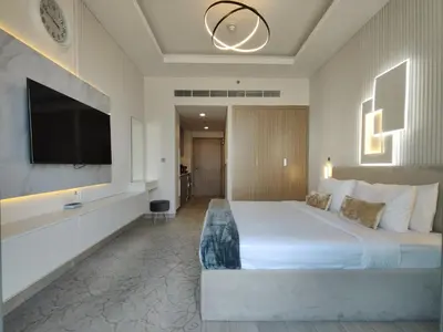 a hotel room with a large bed and a flat screen tv at Farhad Azizi Residence Al Jaddaf in Dubai