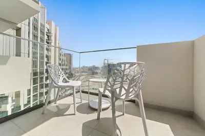 two chairs and a table on a balcony with a view at Farhad Azizi Residence Al Jaddaf in Dubai