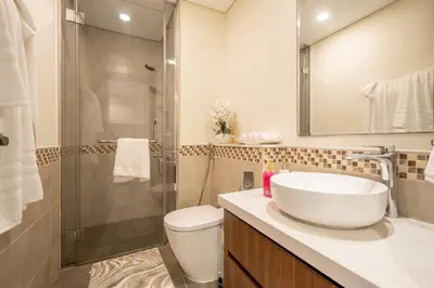 a bathroom with a sink and a shower and a toilet at Stylish 1BR - Burj Khalifa View in Dubai