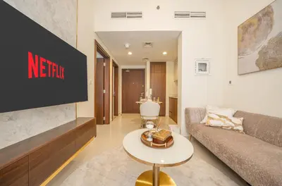 a living room with a couch and a table at Stylish 1BR - Burj Khalifa View in Dubai