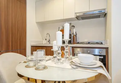 a kitchen with a table with glasses on it at Stylish 1BR - Burj Khalifa View in Dubai