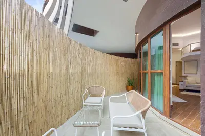 a room with two chairs and a wall at Designer Loft Studio with top Amenities in JVC in Dubai
