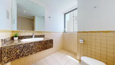 a bathroom with a sink and a mirror and a toilet at Vacationer I Royale 3 Bedroom I Steps to JBR Beach I Jumeirah I Free Gym, Pool, Parking & Wi-Fi in Dubai