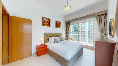 a bedroom with a bed and a large window at Vacationer I Premium 1 Bedroom I Canal View I Business Bay I Free Gym, Pool, Parking & Wi-Fi in Dubai