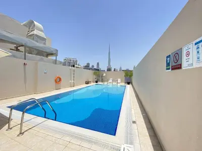 a large swimming pool on top of a building at Vacationer I Premium 1 Bedroom I Canal View I Business Bay I Free Gym, Pool, Parking & Wi-Fi in Dubai