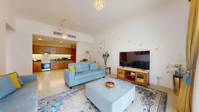 a living room with a blue couch and a tv at Vacationer I Premium 1 Bedroom I Canal View I Business Bay I Free Gym, Pool, Parking & Wi-Fi in Dubai