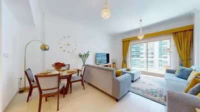 a living room with a table and chairs and a couch at Vacationer I Premium 1 Bedroom I Canal View I Business Bay I Free Gym, Pool, Parking & Wi-Fi in Dubai