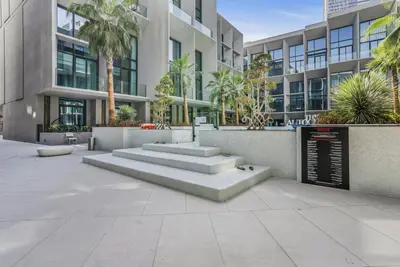 a building with stairs in front of a building at Stylish Studio in The Autograph in Dubai