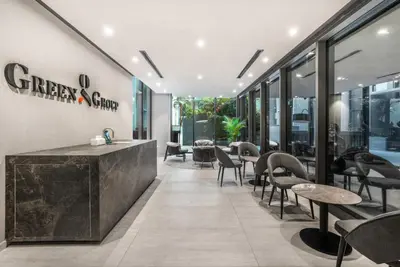 a restaurant with tables and chairs and windows at Stylish Studio in The Autograph in Dubai