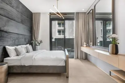 a bedroom with a large bed and a large window at Stylish Studio in The Autograph in Dubai