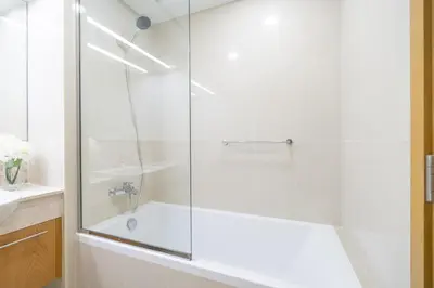 a bathroom with a shower with a tub and a sink at Vogue Downtown Bellevue Towers near Burj Khalifa and Dubai Mall, One Bedroom Apartment with City View, Full Access to all Amenities in Dubai