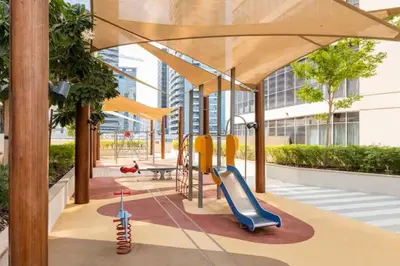 a playground with a slide in a building at Vogue Downtown Bellevue Towers near Burj Khalifa and Dubai Mall, One Bedroom Apartment with City View, Full Access to all Amenities in Dubai