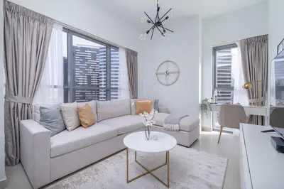 a living room with a couch and a table at Vogue Downtown Bellevue Towers near Burj Khalifa and Dubai Mall, One Bedroom Apartment with City View, Full Access to all Amenities in Dubai
