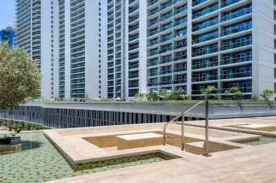 a large building with tall buildings in the background at Studio with a Large Terrace at DAMAC Majestine in Dubai