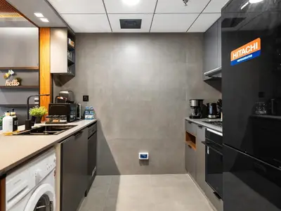 a kitchen with a washer and dryer in a room at Luxury 1 Bedroom Marina Views Walk to Metro and Beach in Dubai