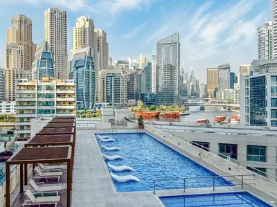 a pool on the roof of a building with a city at Luxury 2 BHK in Dubai Marina By dPie DEC 1907 in Dubai