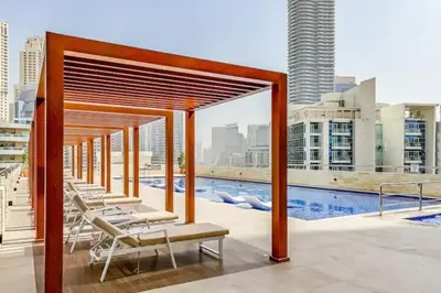 a group of lounge chairs on the roof of a building at Luxury 3BHK in Dubai Marina DEC 1307 in Dubai