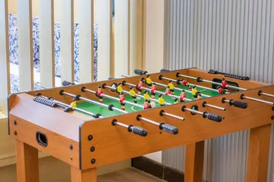 a wooden foosball table with balls on it at Luxury 2 BHK with Floating Bed in Dubai Marina DEC 1803 in Dubai