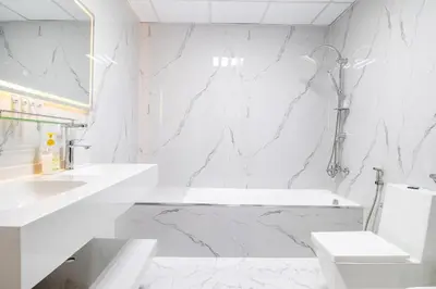a white bathroom with a sink and a toilet at Luxury 2 BHK with Floating Bed in Dubai Marina DEC 1803 in Dubai