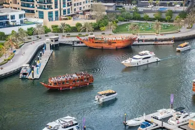 a group of boats in a river with other boats at Lux 3BHK in Dubai Marina w Marina View DEC 1407 in Dubai