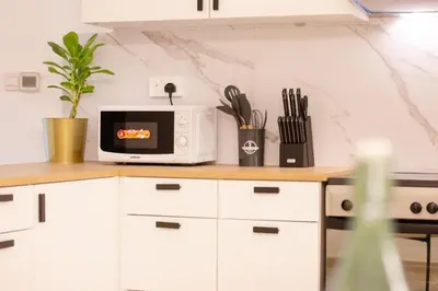 a kitchen with a microwave on a counter at Lux 3BHK in Dubai Marina w Marina View DEC 1407 in Dubai