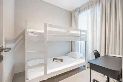 a bedroom with two bunk beds and a desk at Lovely Duplex Townhouse minutes from Downtown in Dubai