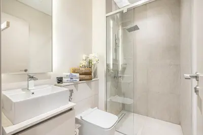 a bathroom with a toilet and a sink and a shower at Lovely Duplex Townhouse minutes from Downtown in Dubai