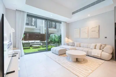 a living room with a couch and a table at Lovely Duplex Townhouse minutes from Downtown in Dubai