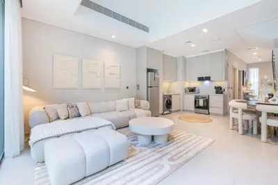 a living room with a couch and a table at Lovely Duplex Townhouse minutes from Downtown in Dubai