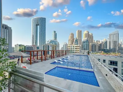 a pool on the roof of a building with a city skyline at Luxury 3BHK in Dubai Marina DEC 1603 in Dubai