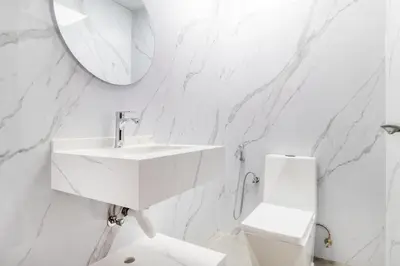 a white bathroom with a sink and a toilet at Luxury 3 BHK in Dubai Marina By dPie Dec 1007 in Dubai
