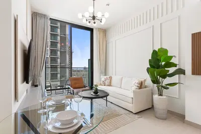 a living room with a couch and a table at Charming 1Bedroom in Binghatti Gardenia in Dubai