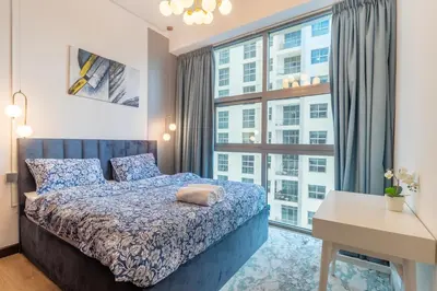 a bedroom with a bed and a large window at Lux 3BHK in Dubai Marina with Marina View DEC 1306 in Dubai