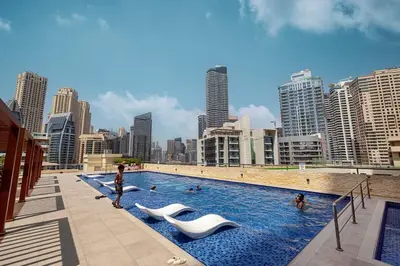 a large swimming pool with people in a city at Luxury 3BHK in Dubai Marina DEC 702 in Dubai