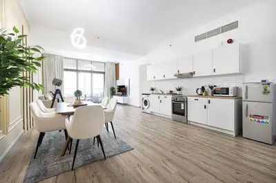 a kitchen and dining room with a table and chairs at Luxury 3BHK in Dubai Marina DEC 702 in Dubai