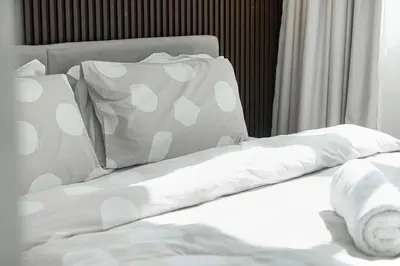a bed with white sheets and pillows on it at Luxury 3BHK in Dubai Marina DEC 702 in Dubai