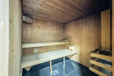 a sauna with wooden walls and a bench in it at Luxury 4 BHK in Dubai Marina DEC 2102 in Dubai