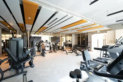 a gym with treadmills and elliptical machines at KeyRock Living - Golf Gate Apt with Pool Access in Dubai