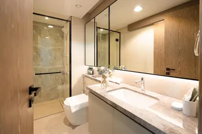a bathroom with a sink and a toilet and a mirror at KeyRock Living - Golf Gate Apt with Pool Access in Dubai