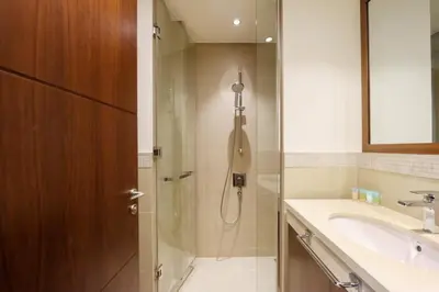 a bathroom with a shower and a sink at Prime Located 2BR Near Burj Khalifa & Dubai Mall in Dubai