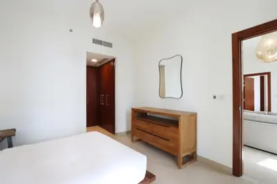 a bedroom with a bed and a dresser and a mirror at Prime Located 2BR Near Burj Khalifa & Dubai Mall in Dubai